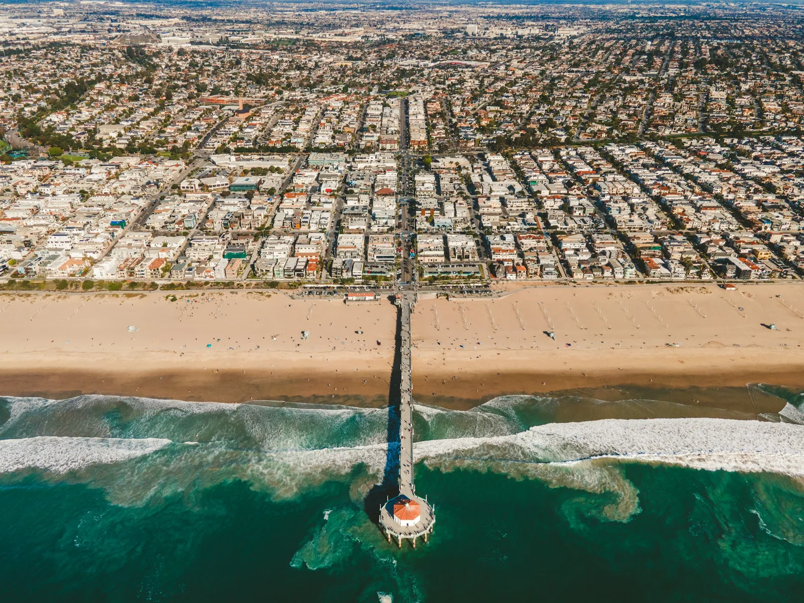 An aerial view of Manhattan Beach pier, the ocean, and the South Bay coastline